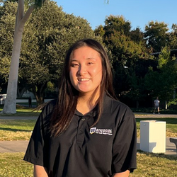 Emily Sarashina smiling and wearing an APSP polo in an individual staff photo