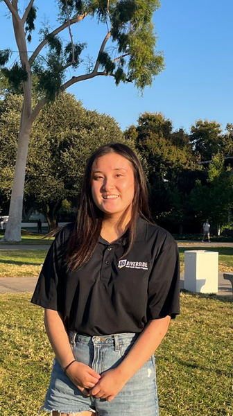 Emily Sarashina smiling and wearing an APSP polo in an individual staff photo